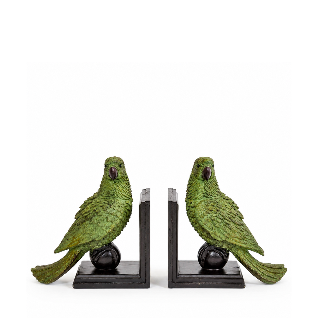 A pair of decorative bookends shaped like green parrots perched on black rectangular bases with round black supports, photographed on a plain white background.