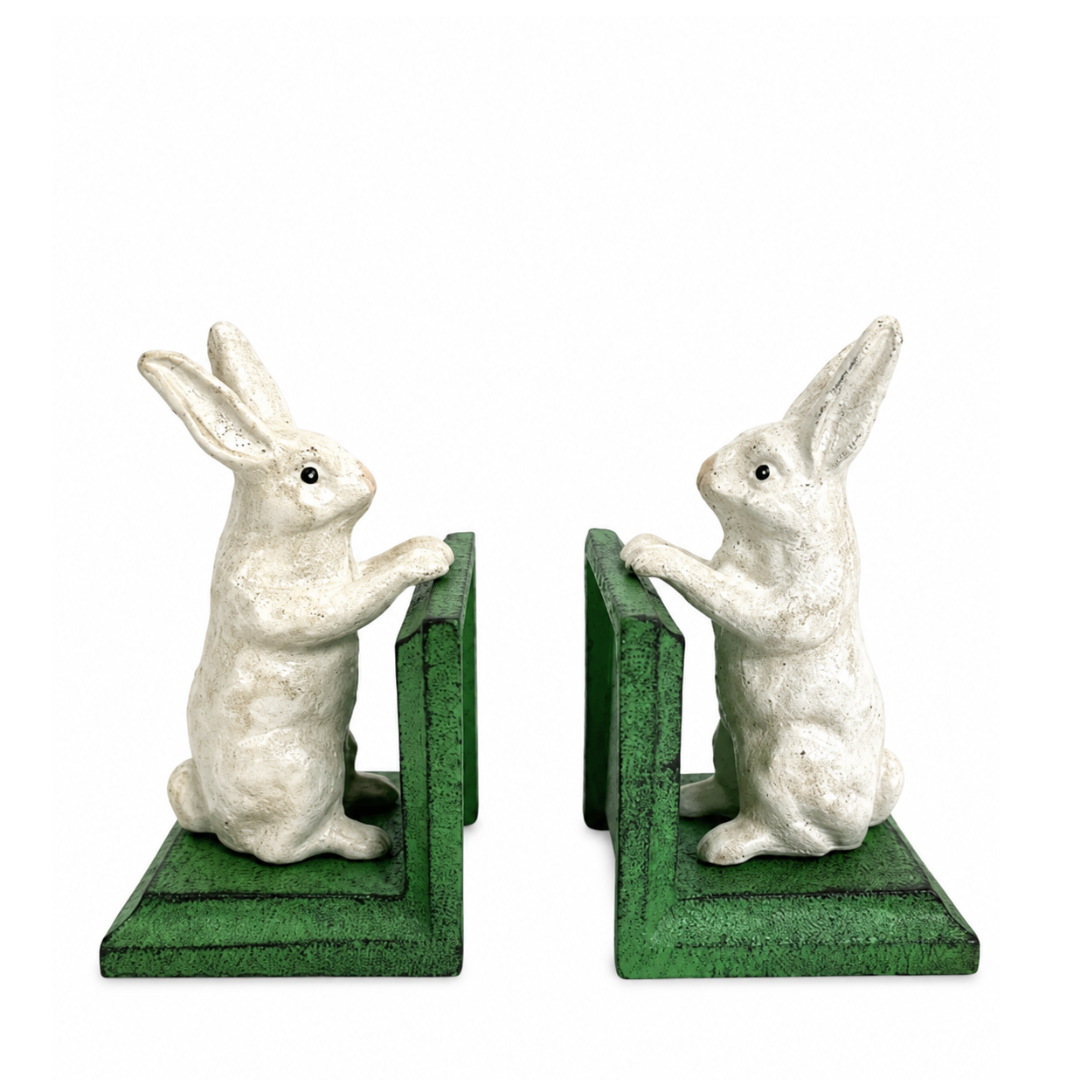 A pair of decorative rabbit bookends featuring white rabbit figurines with raised front paws, set against green L-shaped bookend bases on a plain white background.