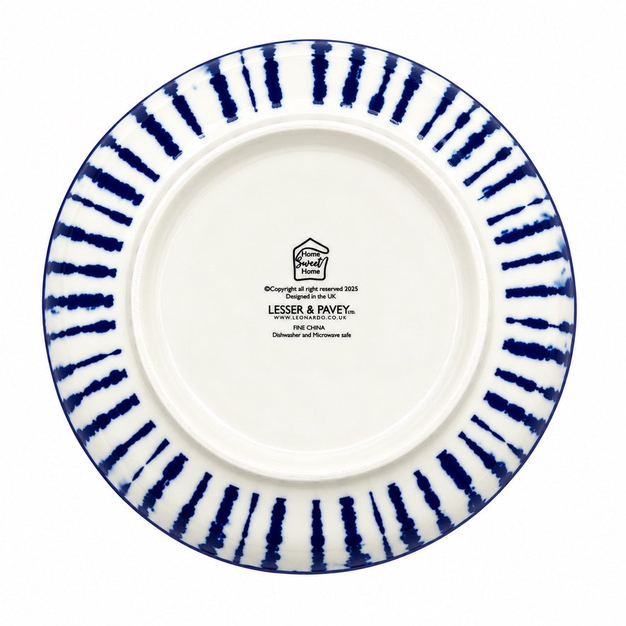 The underside of a white ceramic plate with a blue painted border featuring vertical brushstroke patterns radiating from the rim, and black printed brand text in the center.