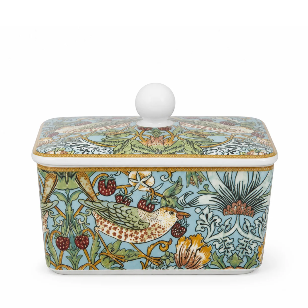 A rectangular ceramic butter dish with a lid, featuring a detailed William Morris-style botanical and bird pattern in light blue, green, gold, red, and cream on a white background.