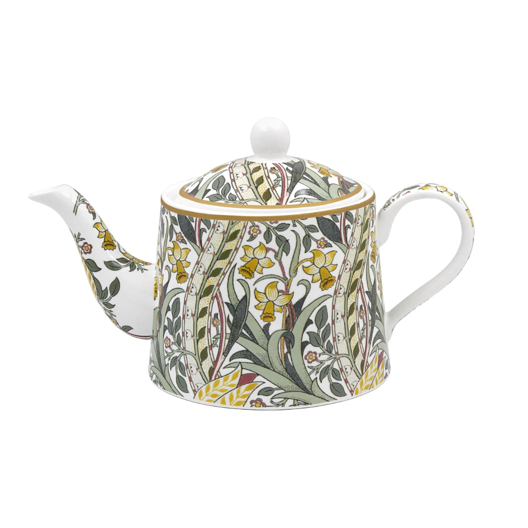 A white porcelain teapot decorated with a detailed William Morris-style floral pattern featuring yellow daffodils, green leaves, and gold accents, shown on a plain white background.