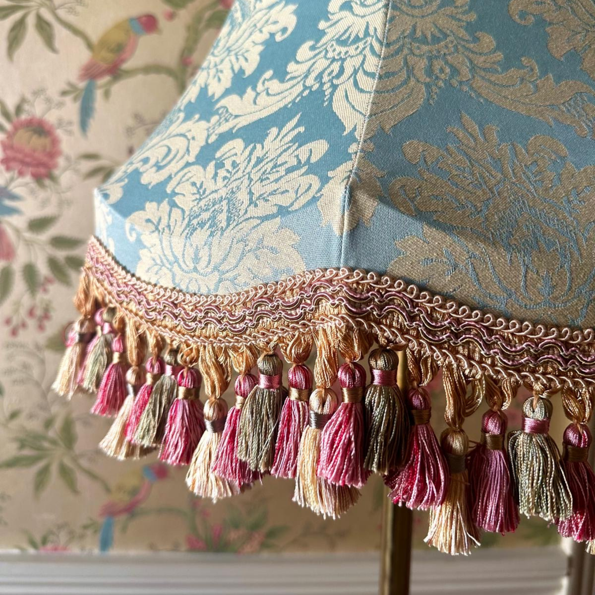 Decorative lampshade with tassels on a floral background