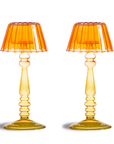a pair of glass candle holder in orange glass for inside house
