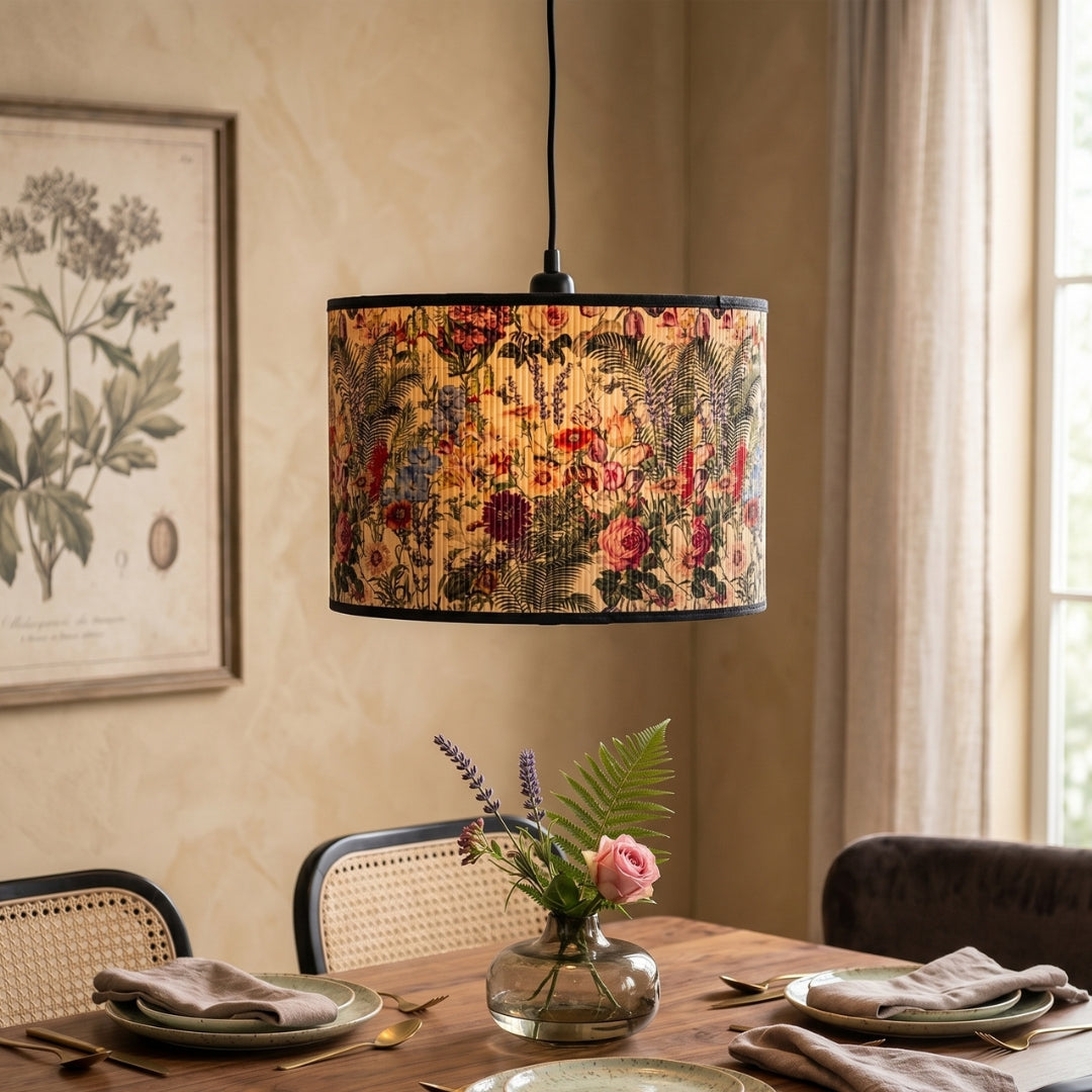 Floral-patterned lampshade hanging above a dining table with a vase of flowers.
