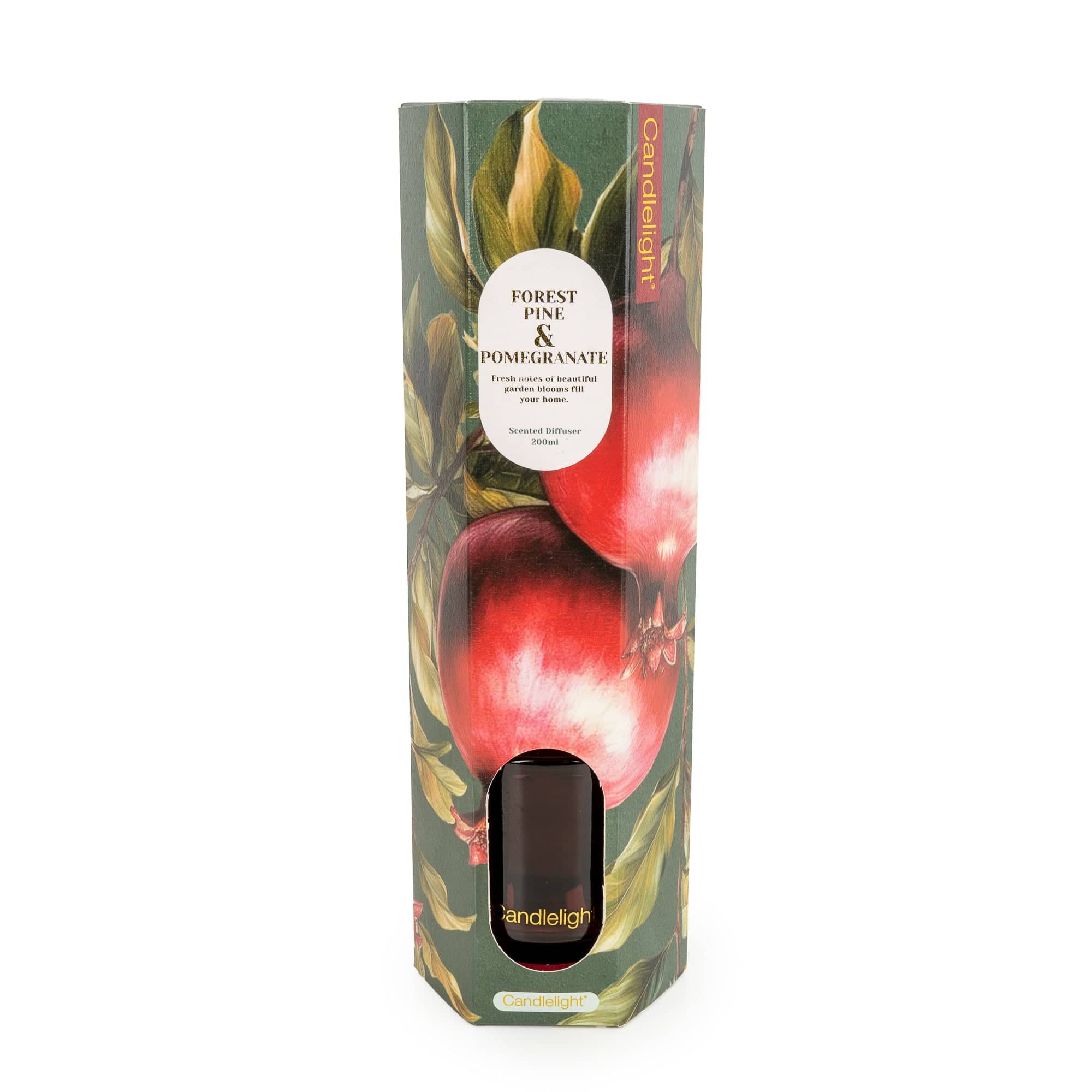 A tall, narrow retail box for a candle, featuring botanical artwork of pomegranates and leaves with a white oval label reading 'Forest Pine & Pomegranate.' The front has a die-cut window showing a dark brown candle inside.