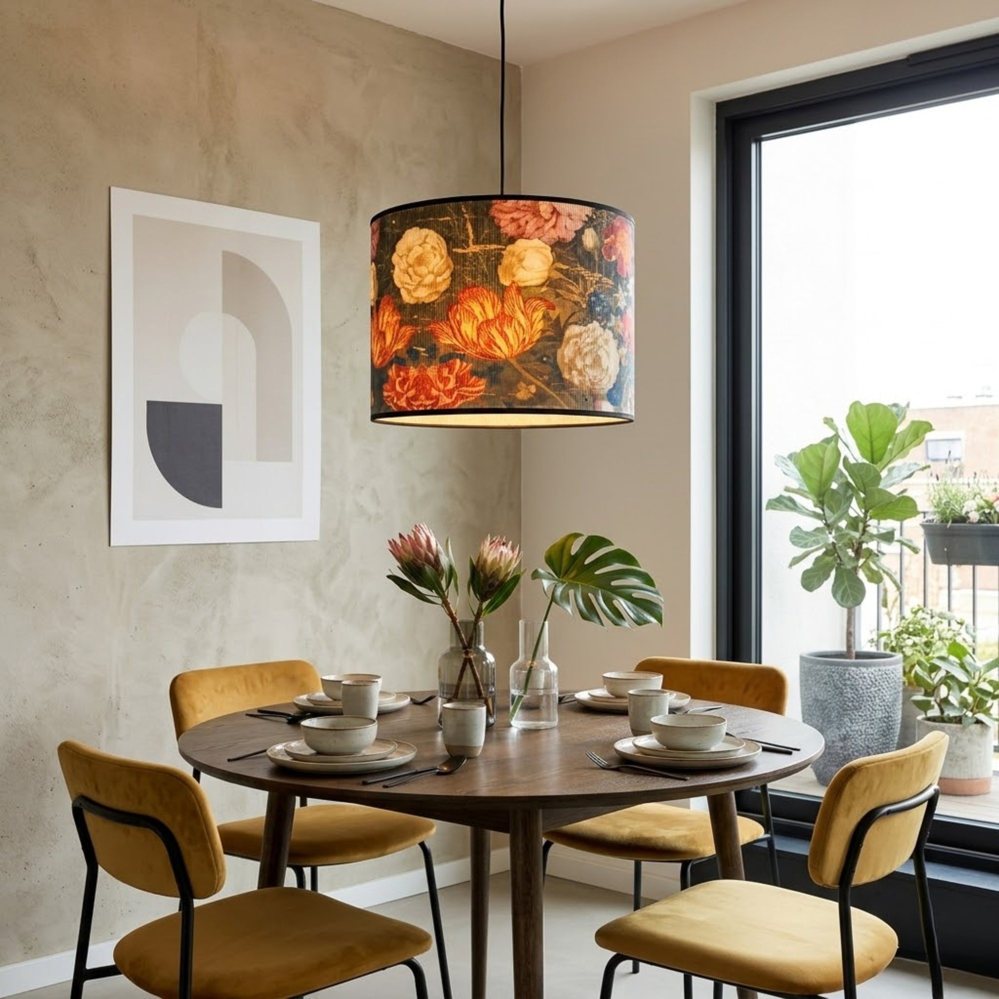 Dining room with a round table, chairs, and a floral pendant light.