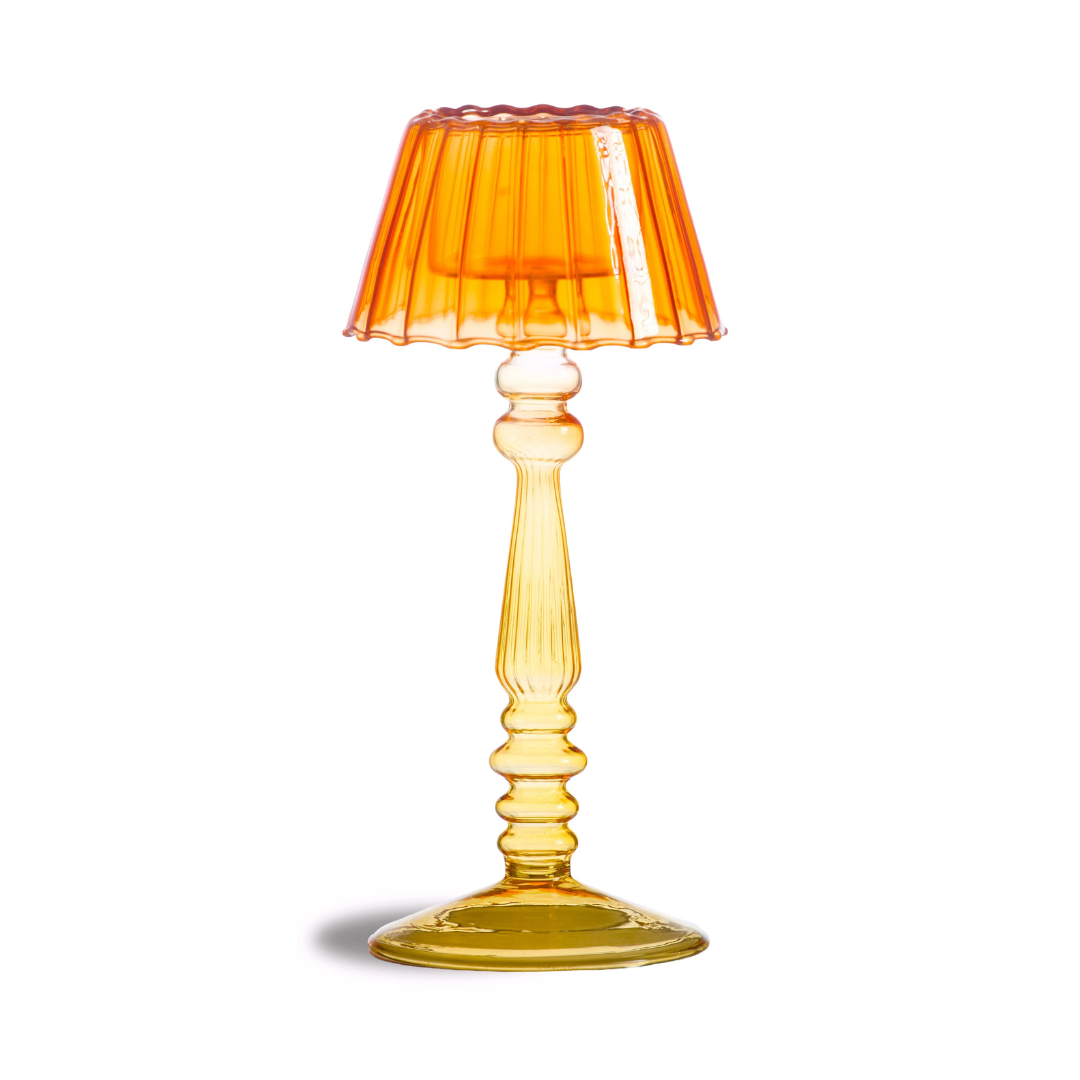 An amber yellow glass table lamp with a pleated shade and a ribbed pedestal base, shown on a white background with a soft shadow.