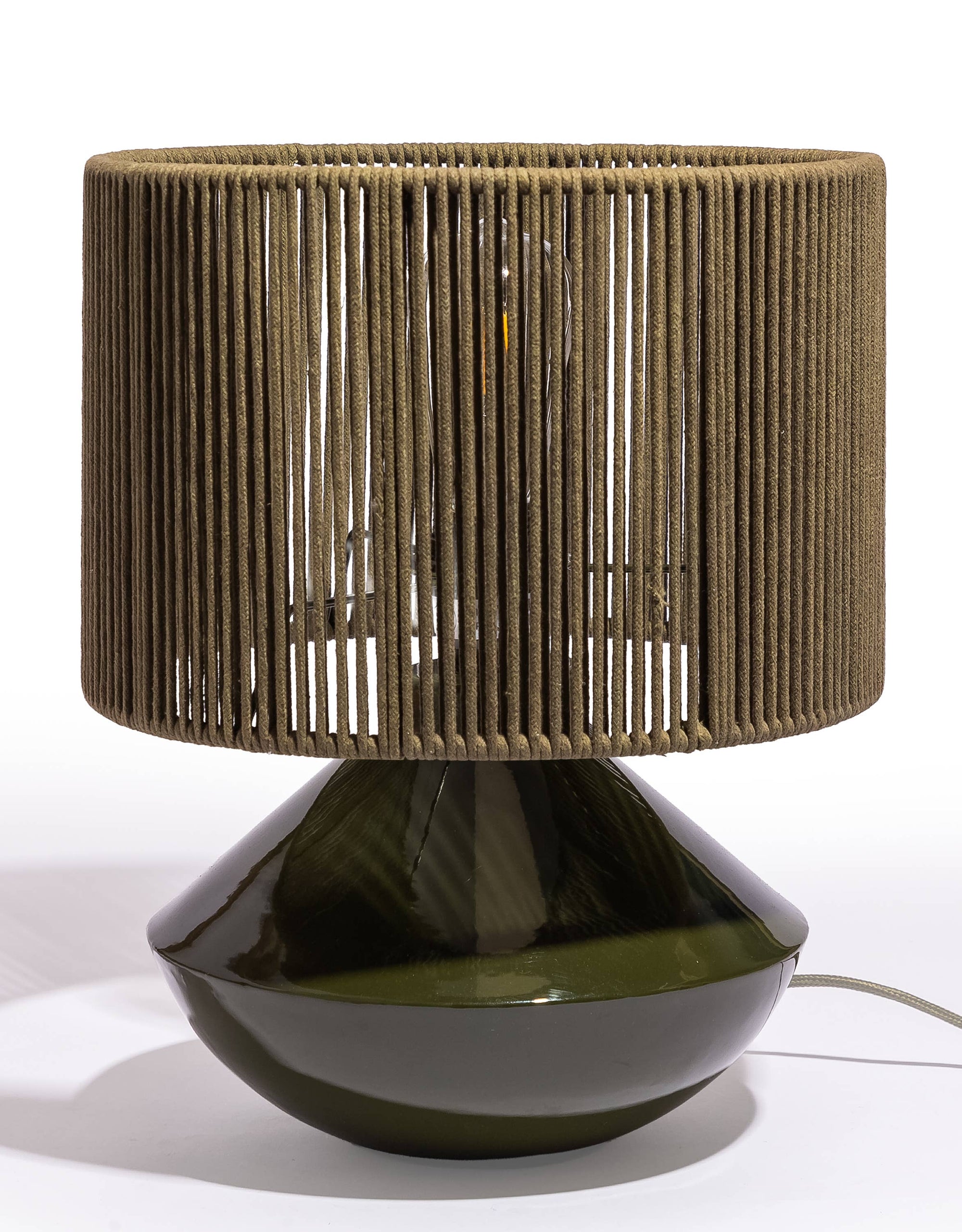 Table lamp with woven brown shade and dark base on a white background