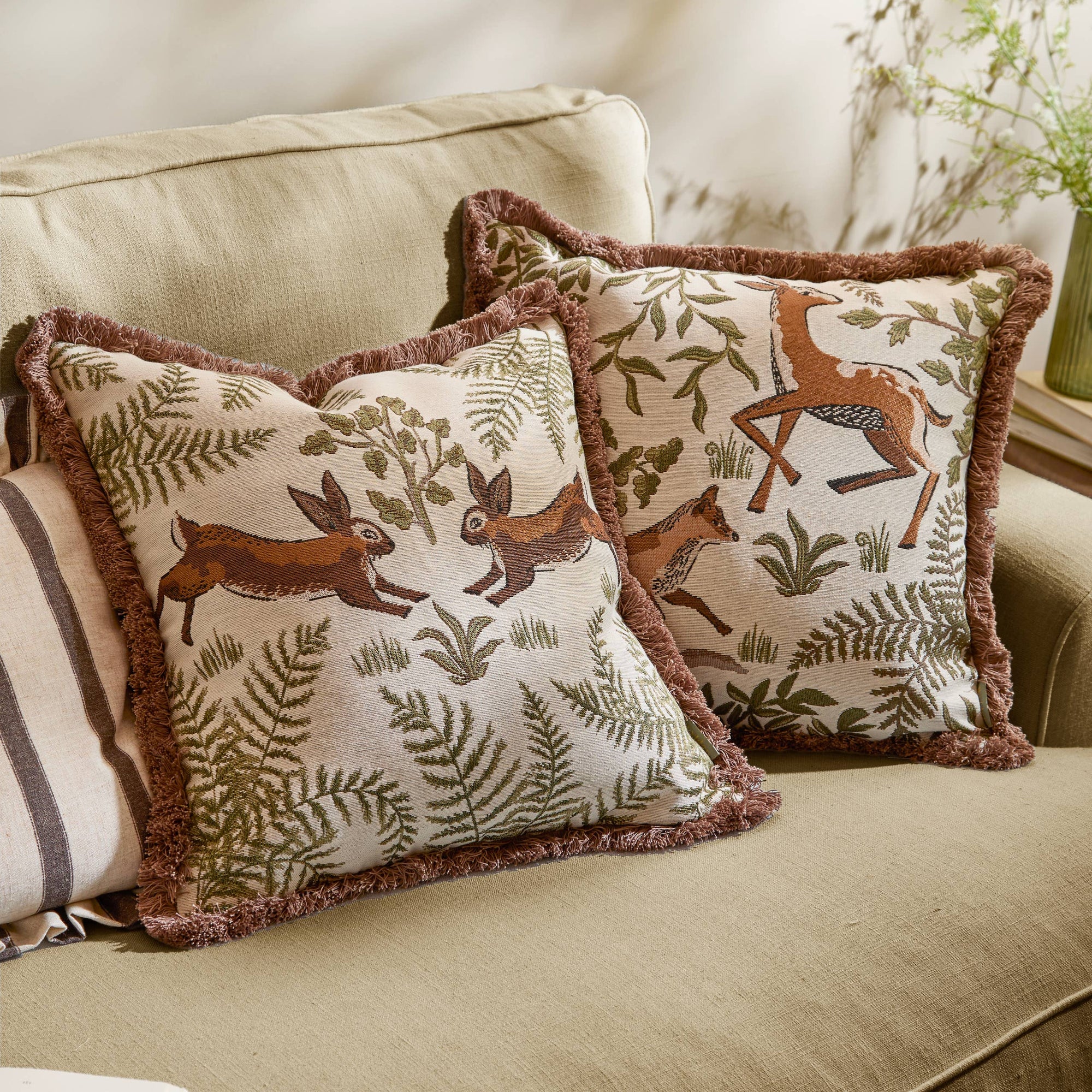 Decorative pillows with animal patterns on a beige sofa