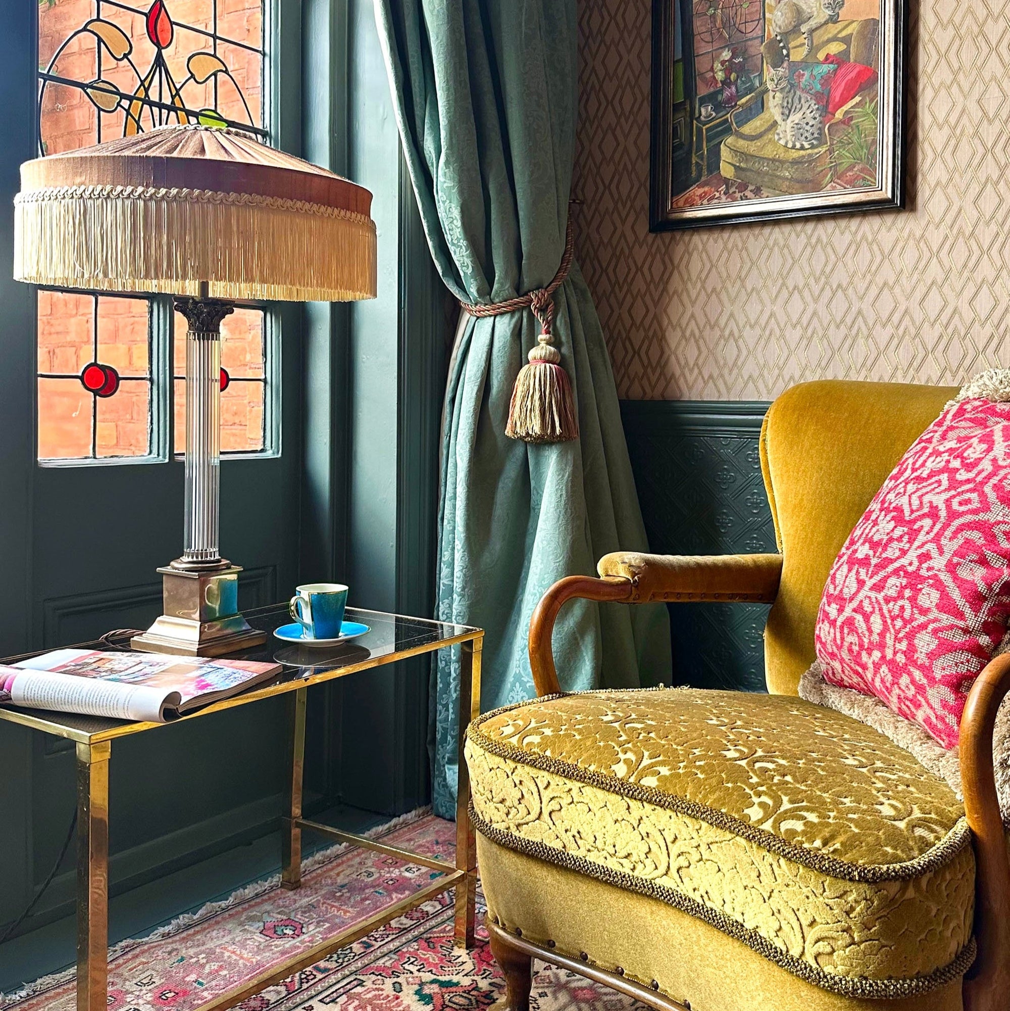 Vintage-style room with yellow armchair, lamp, and decorative elements.