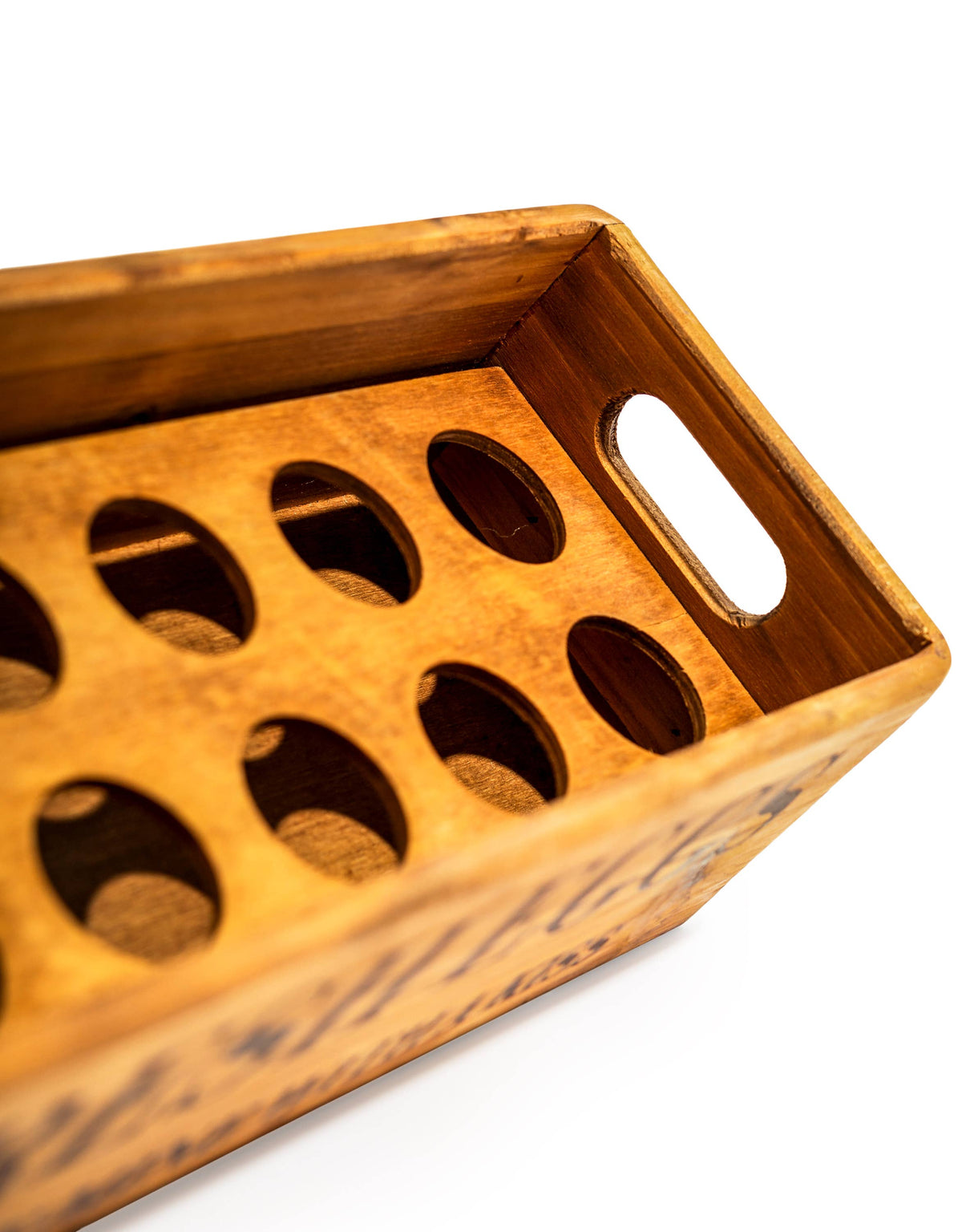 Wooden tray with circular holes on a white background