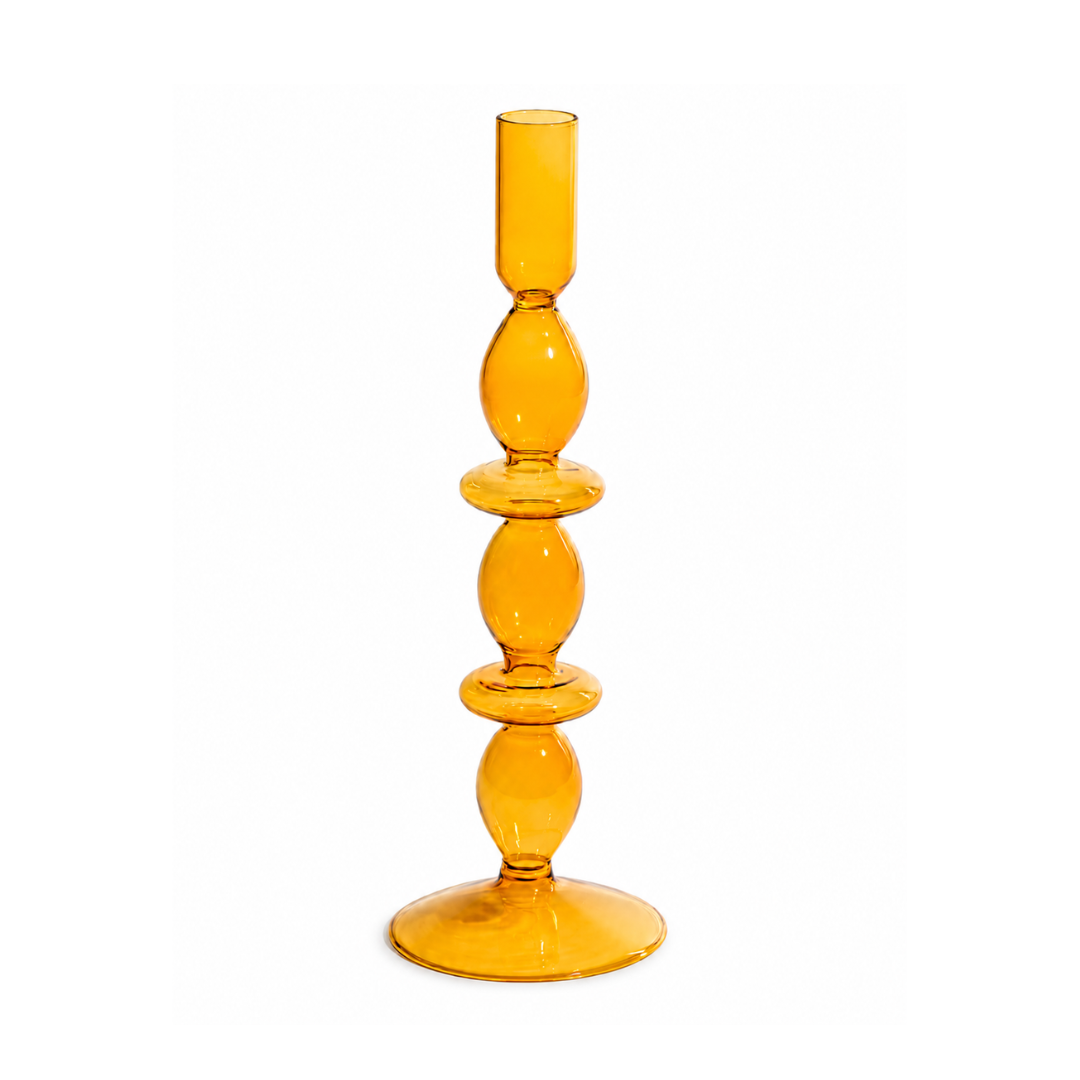 An amber yellow glass candlestick holder with a tiered, bulbous design and a cylindrical candle socket at the top, shown on a plain white background.